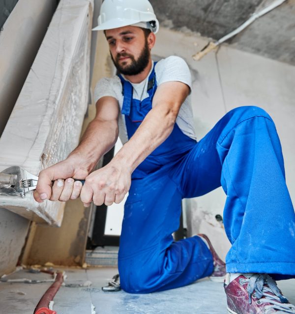 plumber-screwing-plumbing-fittings-with-a-wrench.jpg plumber-screwing-plumbing-fittings-with-a-wrench.jpg